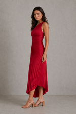 Woman wearing a red dress against a neutral background