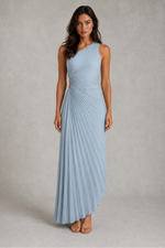 Woman wearing a light blue dress against a gray background