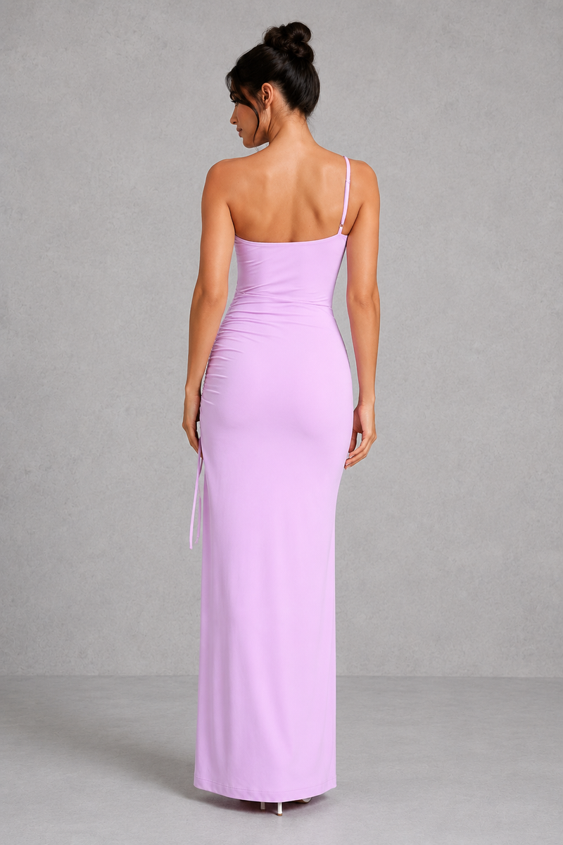 Woman wearing a long lavender dress against a gray background