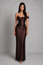 Woman wearing a brown strapless gown against a gray background