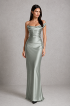 Woman wearing a silver evening gown against a gray background