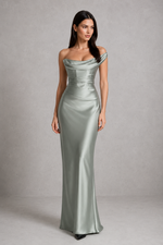Woman wearing a silver evening gown against a gray background
