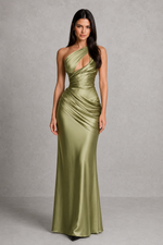 Woman wearing a green evening gown against a gray background