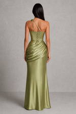 Woman wearing a green satin gown with a gray background