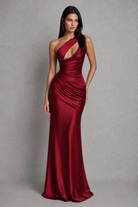 Woman wearing a red evening gown against a gray background