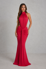 Red evening gown with cut-out design on a plain background