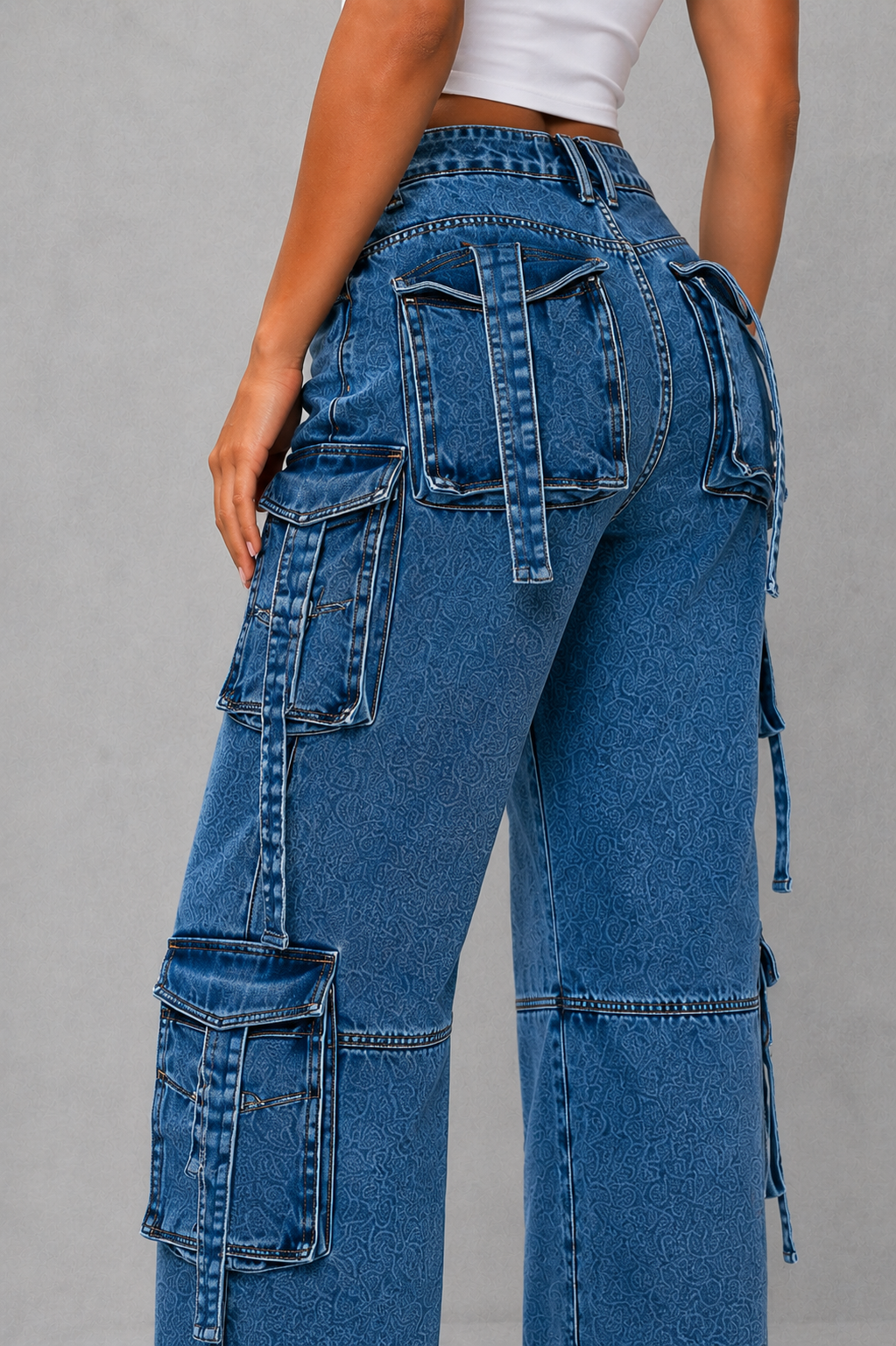 Blue cargo jeans with multiple pockets on a gray background