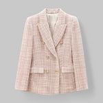 Pink textured blazer with gold buttons on a gray background
