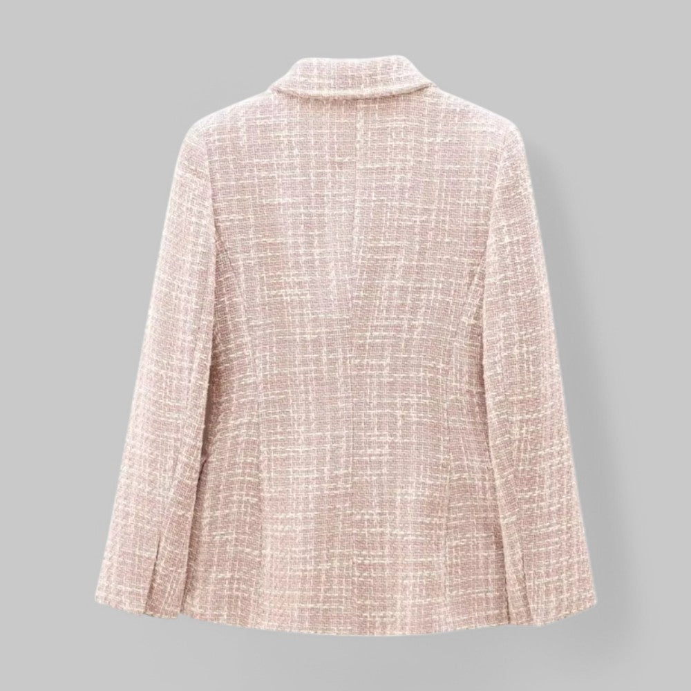 Light pink textured blazer on a gray background