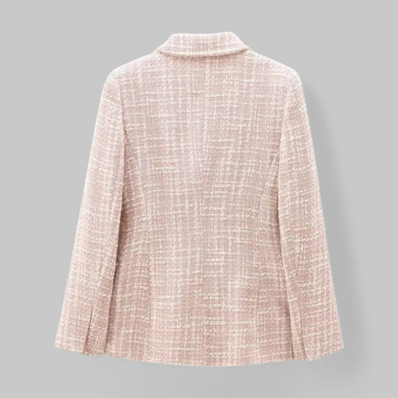 Light pink textured blazer on a gray background