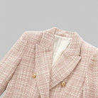 Pink textured blazer with gold buttons on a gray background