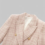 Pink textured blazer with gold buttons on a gray background