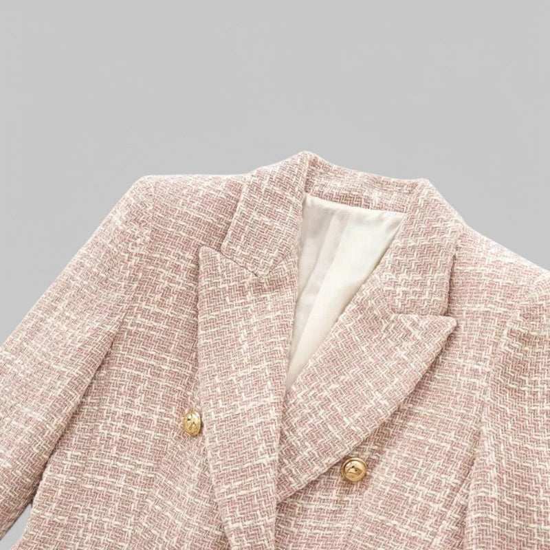 Pink textured blazer with gold buttons on a gray background