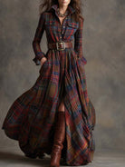 Long plaid dress with a belt and brown boots on a neutral background