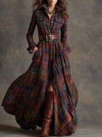 Long plaid dress with a belt and brown boots on a neutral background