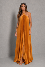 Women’s golden orange pleated halterneck maxi dress with a cross-front neckline, open back, and flowing floor-length silhouette for wedding guests and formal occasions