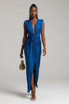 Woman wearing a blue dress with a plain background