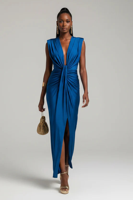 Woman wearing a blue dress with a plain background