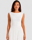 Woman wearing a white dress against a plain background