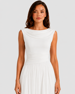 Woman wearing a white dress against a plain background