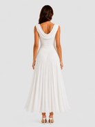 Woman wearing a white sleeveless dress on a plain background