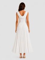 Woman wearing a white sleeveless dress on a plain background