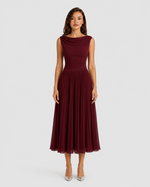 Woman wearing a burgundy dress on a white background