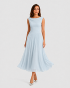Woman wearing a light blue dress on a white background