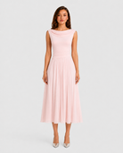 Woman wearing a pink dress on a light gray background