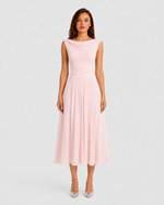 Woman wearing a pink dress on a light gray background