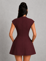 Burgundy dress worn by a person on a gray background