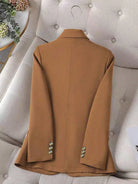 Brown coat on a gray sofa with decorative elements in the background