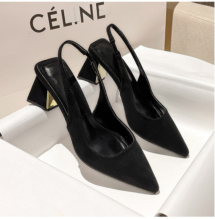 Black pointed-toe high-heeled shoes on a white surface with 'Cél.è' branding in the background.