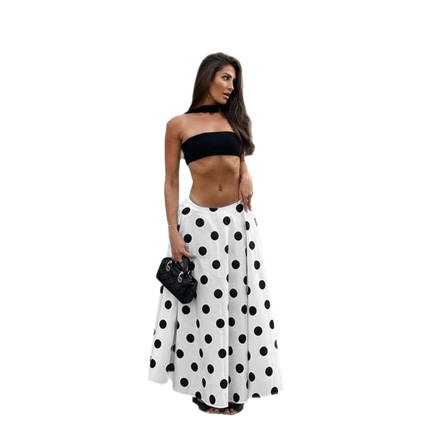 Woman wearing a black strapless top and white polka dot pants on a white background