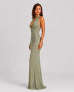 Woman wearing a green evening gown on a white background