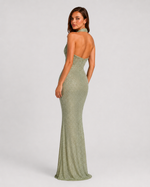 Woman wearing a green evening gown on a white background