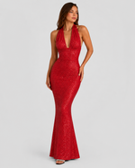 Red glittery halter neck gown on a plain background