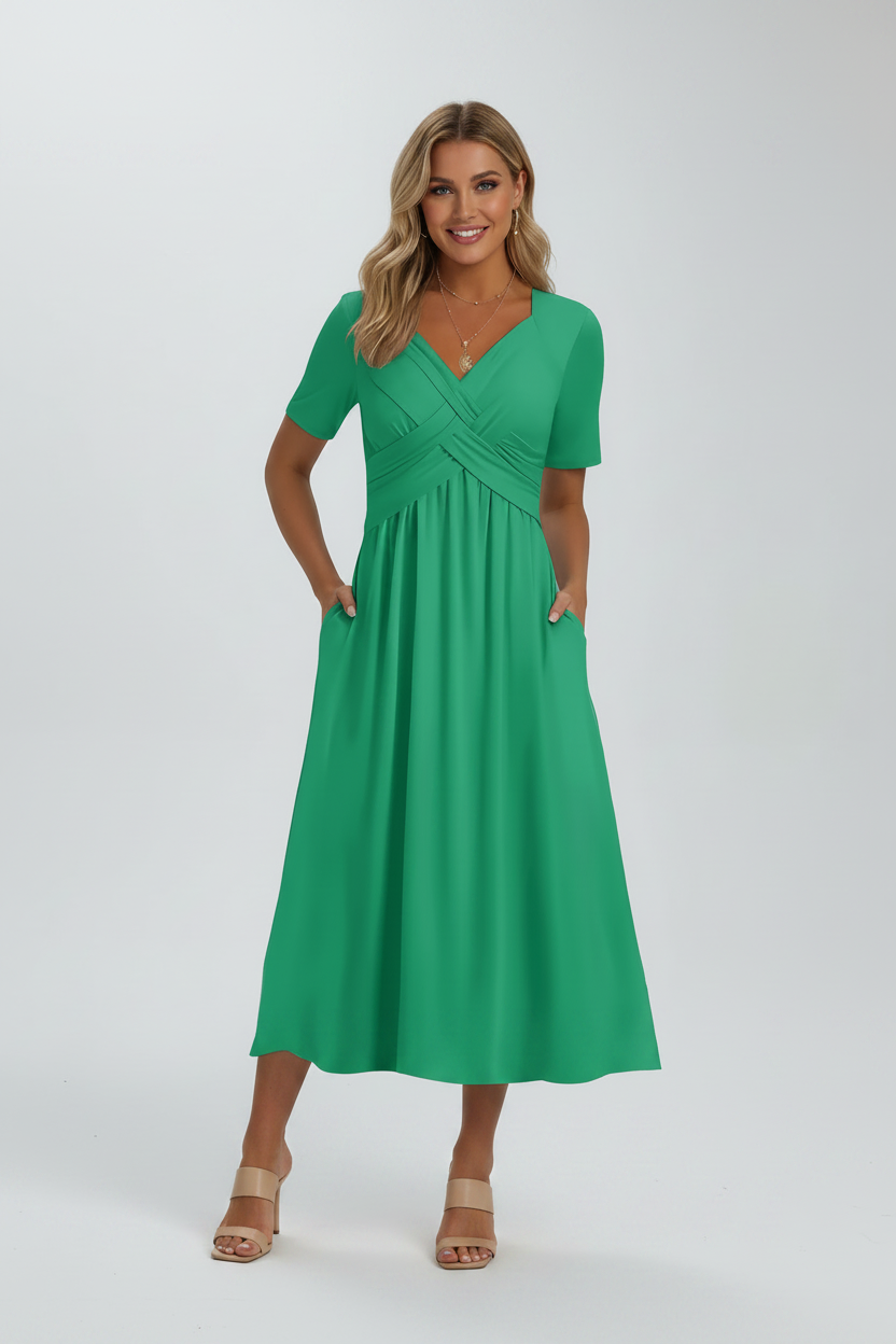 Green dress worn by a person with a blurred outdoor background
