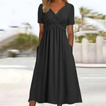 Black dress worn by a person with a blurred outdoor background