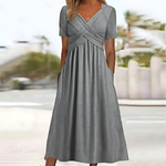 Gray dress worn by a person with a blurred outdoor background