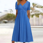 Blue dress worn by a person with a blurred outdoor background