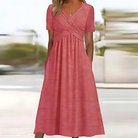 Pink dress worn by a person with a blurred outdoor background