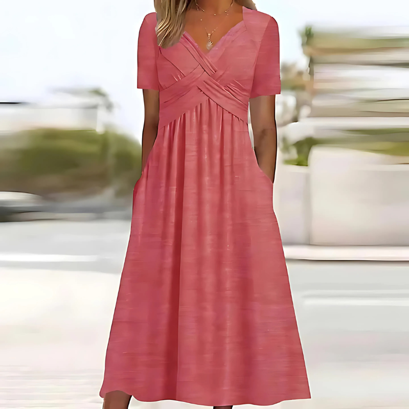 Pink dress worn by a person with a blurred outdoor background