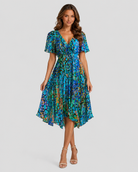 Woman wearing a blue floral dress on a gray background