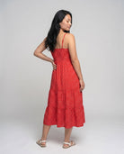 Woman wearing a red dress with a white background