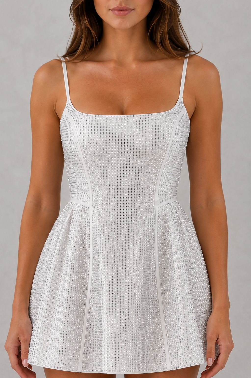 White patterned dress worn by a model on a gray background