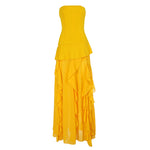 Yellow strapless dress with ruffled layers on a white background