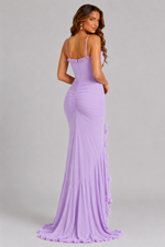 Woman wearing a purple evening gown with a plain background