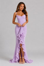 Woman wearing a lavender evening gown with floral details on a gray background