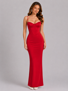 Woman wearing a red evening gown against a gray background